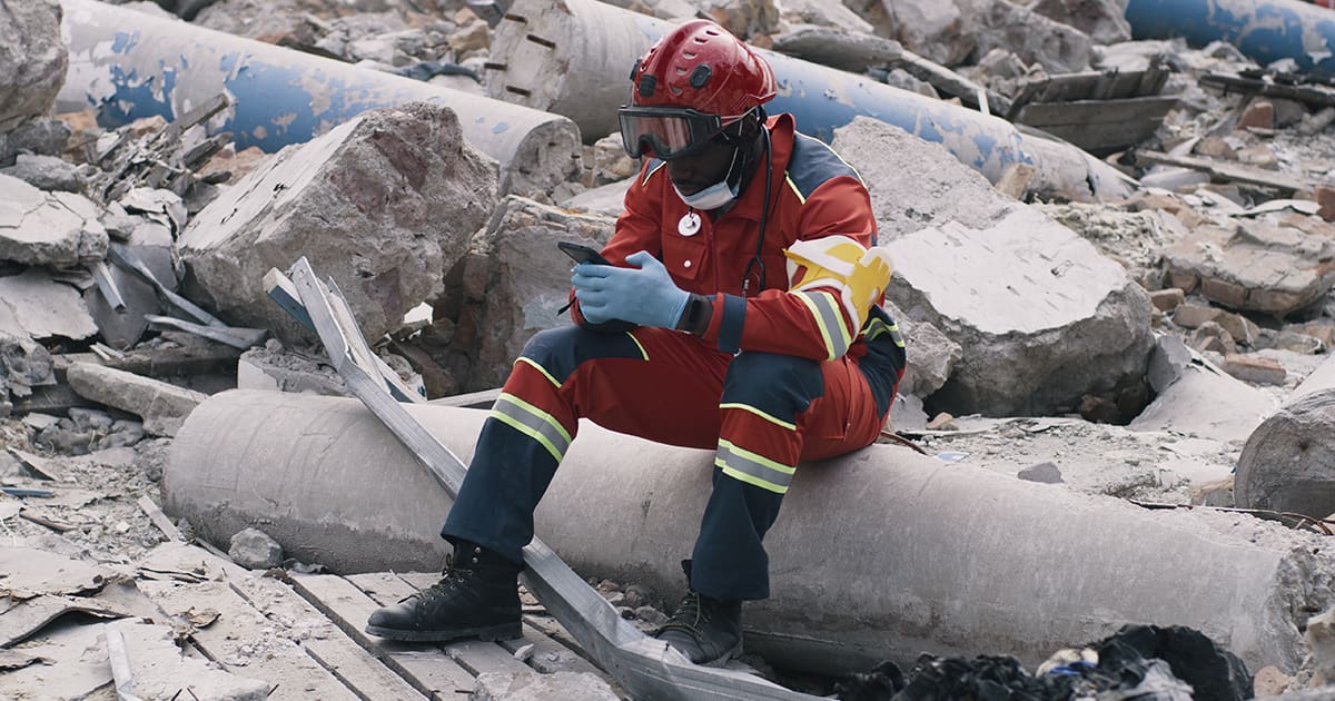Black paramedic using smartphone after disaster - LabLynx